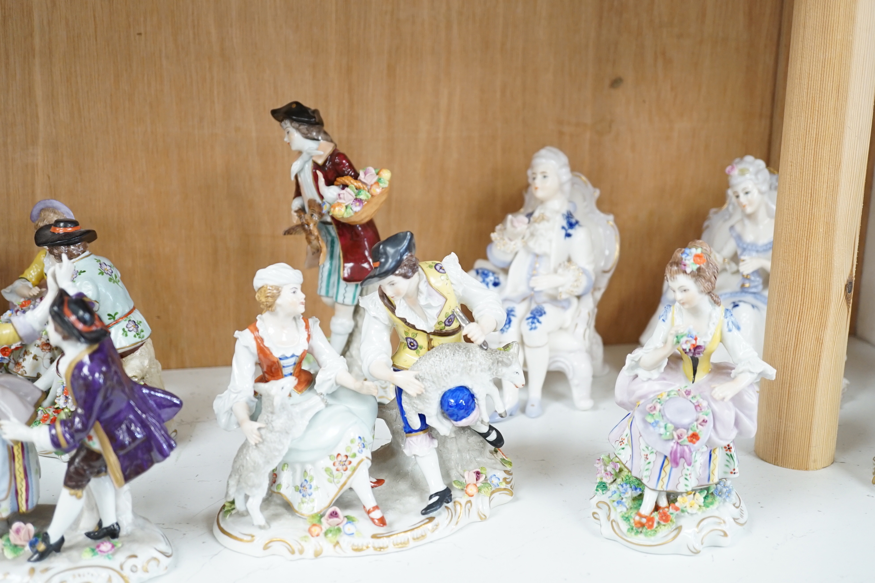 A quantity of porcelain figures and groups including eight Sitzendorf examples and Royal Doulton Marie, HN1635, the largest 19cm high